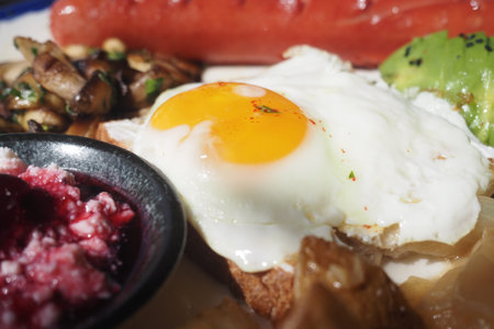 Delicious breakfast featuring egg, avocado, and sausage