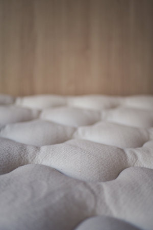 Close-up view of a plush mattress surface with textureの写真素材