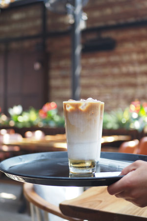 Coffee served on a tray in a cozy cafe settingの写真素材
