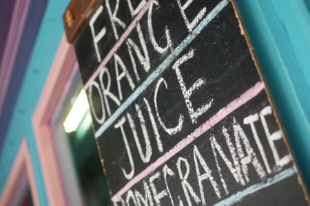 Fresh orange juice and pomegranate sign at local cafeの写真素材