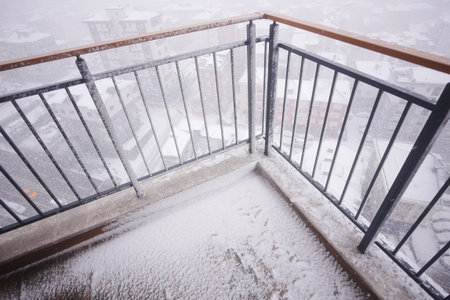 Snowfall covers balcony in winter storm at mountain locationの写真素材
