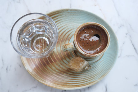 Traditional turkish coffee with water served on a rustic plate
