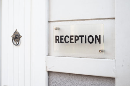 Reception area with a clear sign on the entranceの写真素材