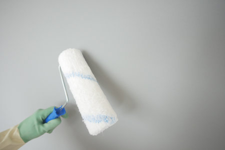 Preparing walls with a paint roller for a fresh lookの写真素材
