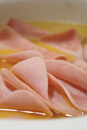 Thin slices of deli meat are soaked in a flavorful broth.