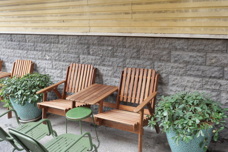 Comfortable seating arrangement by the wall with greeneryの写真素材