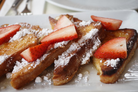 French toast with strawberries and powdered sugarの写真素材