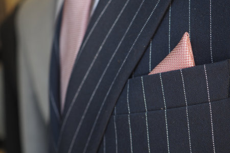 Elegant suit with pink pocket square on displayの写真素材