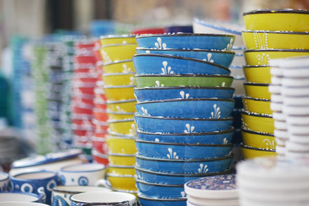 Brightly colored stacked bowls at a market display