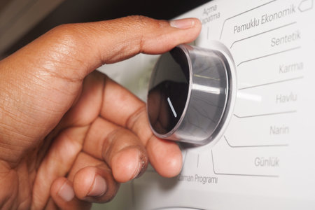 Adjusting the settings on a washing machine at home