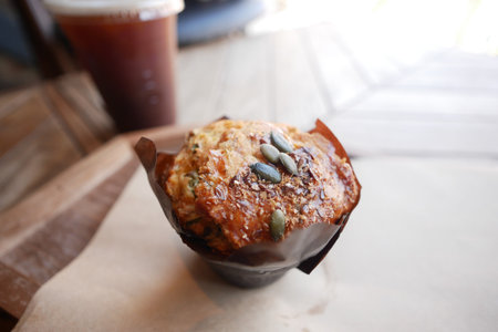 Muffin and cold brew coffee on a rustic wooden tableの写真素材