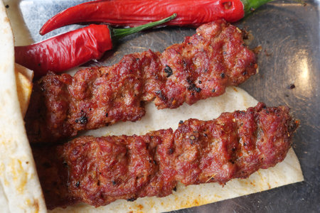 Delicious grilled kebab served with fresh chili peppersの写真素材