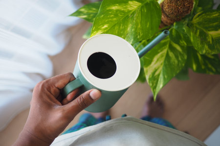 Enjoying a cup of coffee next to a thriving plantの写真素材