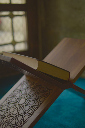 Open book resting on wooden stand with intricate designの写真素材