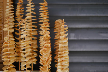 Unique wooden spiral sculptures displayed at outdoor marketの写真素材