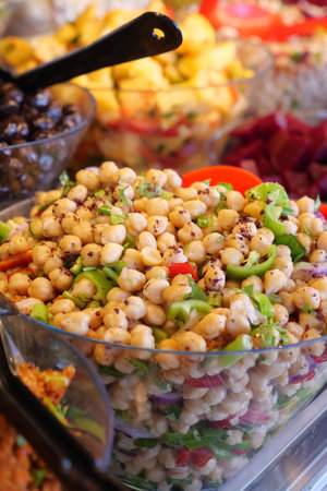 Colorful chickpea salad displayed at a vibrant market stallの写真素材