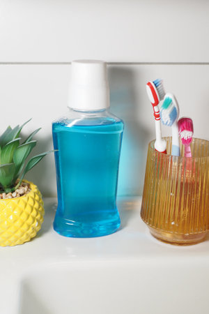 Bright bathroom setup with mouthwash and toothbrush holdersの写真素材