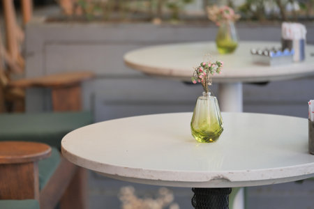 Decorative vase on a table in a cozy cafe settingの写真素材