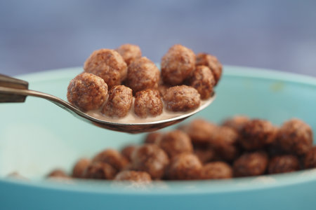 Pouring cereal into milk for a delicious breakfast mealの写真素材