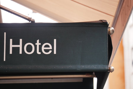 Hotel entrance sign at a busy city location in daylightの写真素材
