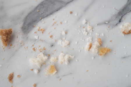 Crumbs scattered on a marble surface after a mealの写真素材