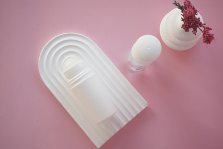 Decorative deodorant arranged on a pink surfaceの写真素材
