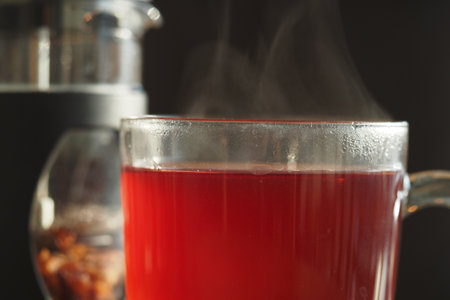 Brewing a warm cup of herbal tea in a cozy kitchen settingの写真素材