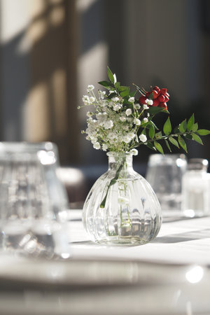 Centerpiece with flowers in a dining settingの写真素材
