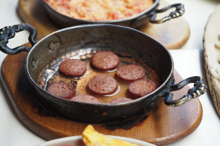 Delicious sausages served in a traditional skilletの写真素材