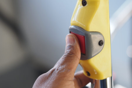 Hand pressing stop button on public transport vehicleの写真素材
