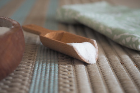 Wooden scoop holding baking soda on a carpetの写真素材