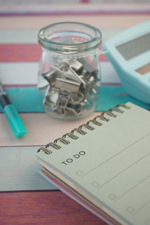 Organizing tasks with a to-do list and stationery essentialsの写真素材