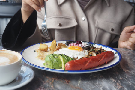Enjoying a hearty breakfast at a local cafe in the morningの写真素材