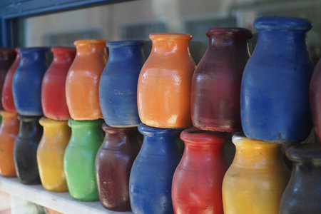 Colorful clay pots displayed in a local market stallの写真素材