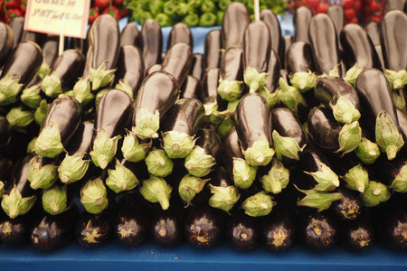 Fresh eggplants arranged at a local market stallの写真素材