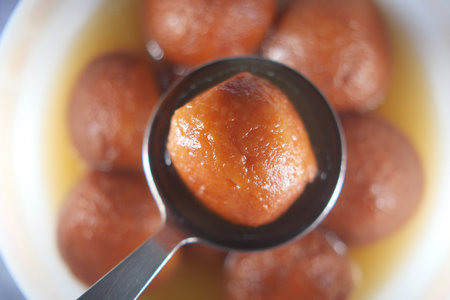 Indian Sweet dessert on a spoonの写真素材