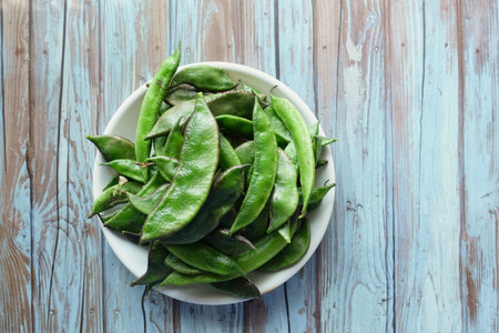 Fresh green beans harvested from a garden bowlの写真素材