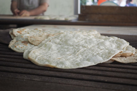 Fresh flatbreads on a wooden surfaceの写真素材