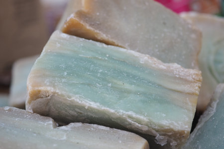 Natural soap bars in soft blue and cream colors on displayの写真素材