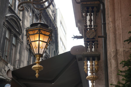 Vintage street lamp illuminated in urban settingの写真素材