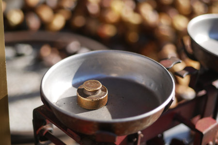 Balance scale displaying a weight in a market settingの写真素材