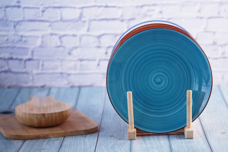 Colorful decorative plates displayed on a wooden tableの写真素材