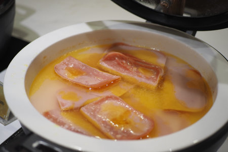 Cooking slices of meat in broth at a buffet setting
