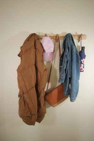 Cozy collection of outerwear and accessories on a wall hookの写真素材