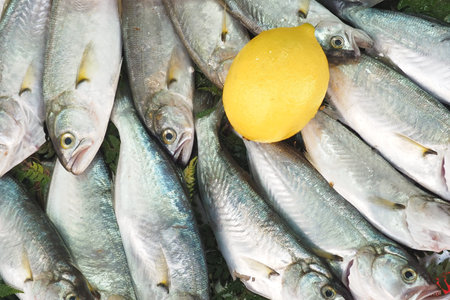 Freshly caught fish arranged with lemon in a market setting