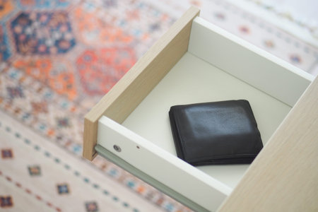 A black wallet rests in an open drawer