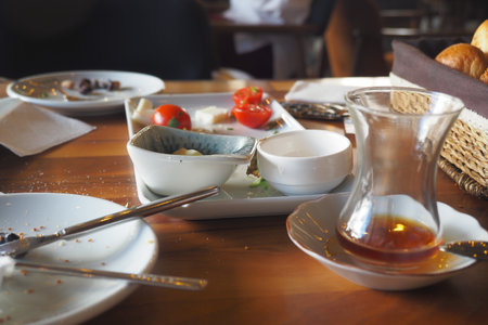 empty plates and cups after a meal on a tableの写真素材