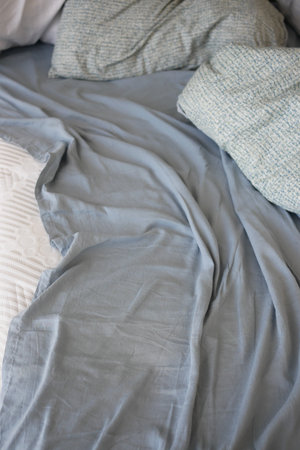 closeup of messy bed at early morningの写真素材