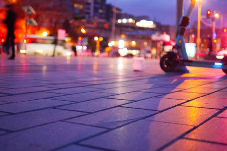 Evening city street with electric scooter parked at duskの写真素材