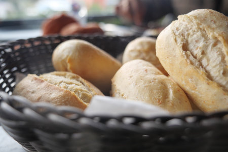 Freshly baked bread rolls in a woven basket